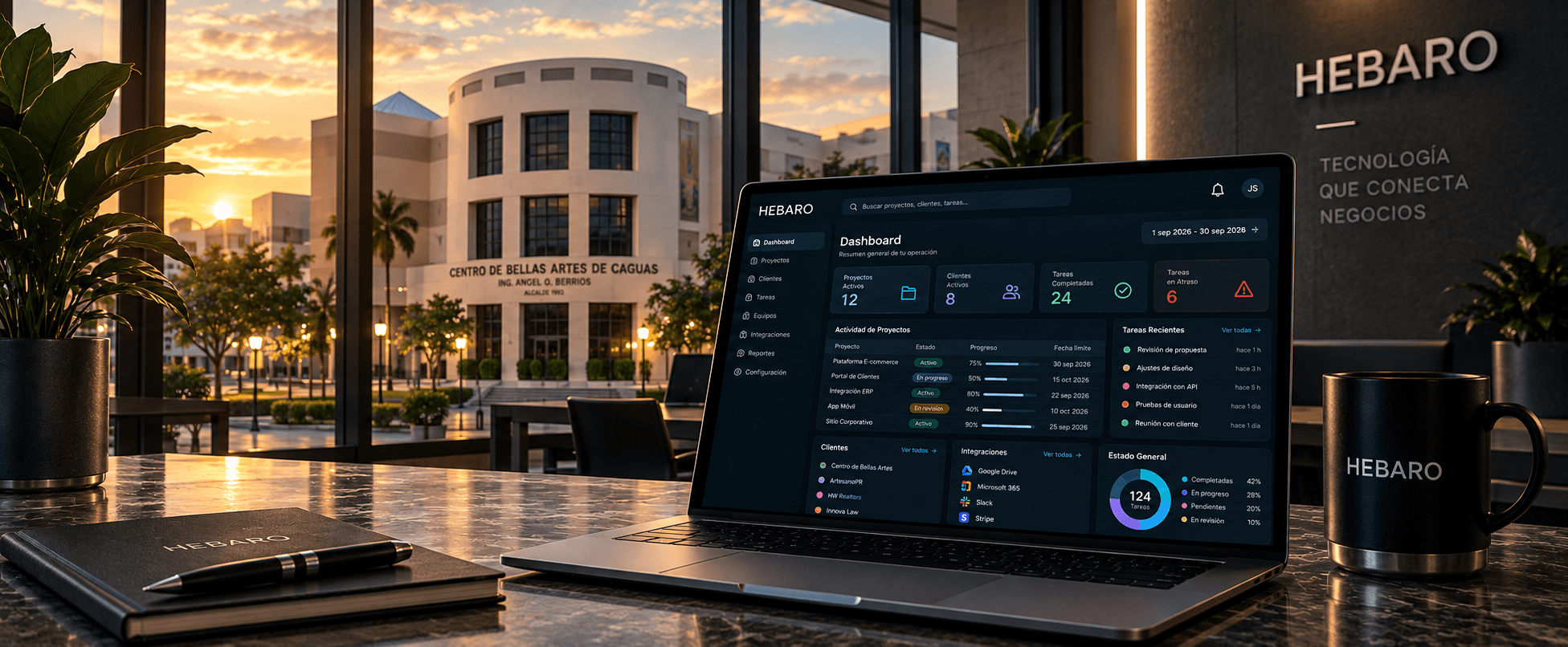 Centro de Bellas Artes de Caguas al atardecer, con un dashboard HEBARO en una computadora portátil.
